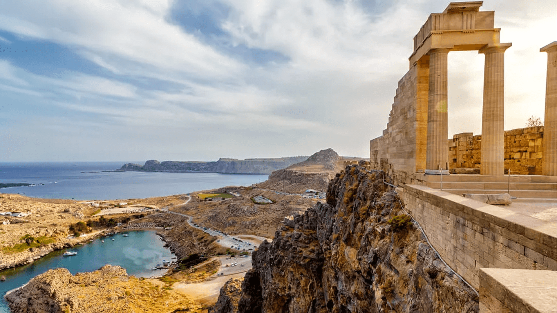 The Acropolis of Lindos in Rhodes, Greece, overlooking the whitewashed village and Aegean Sea.