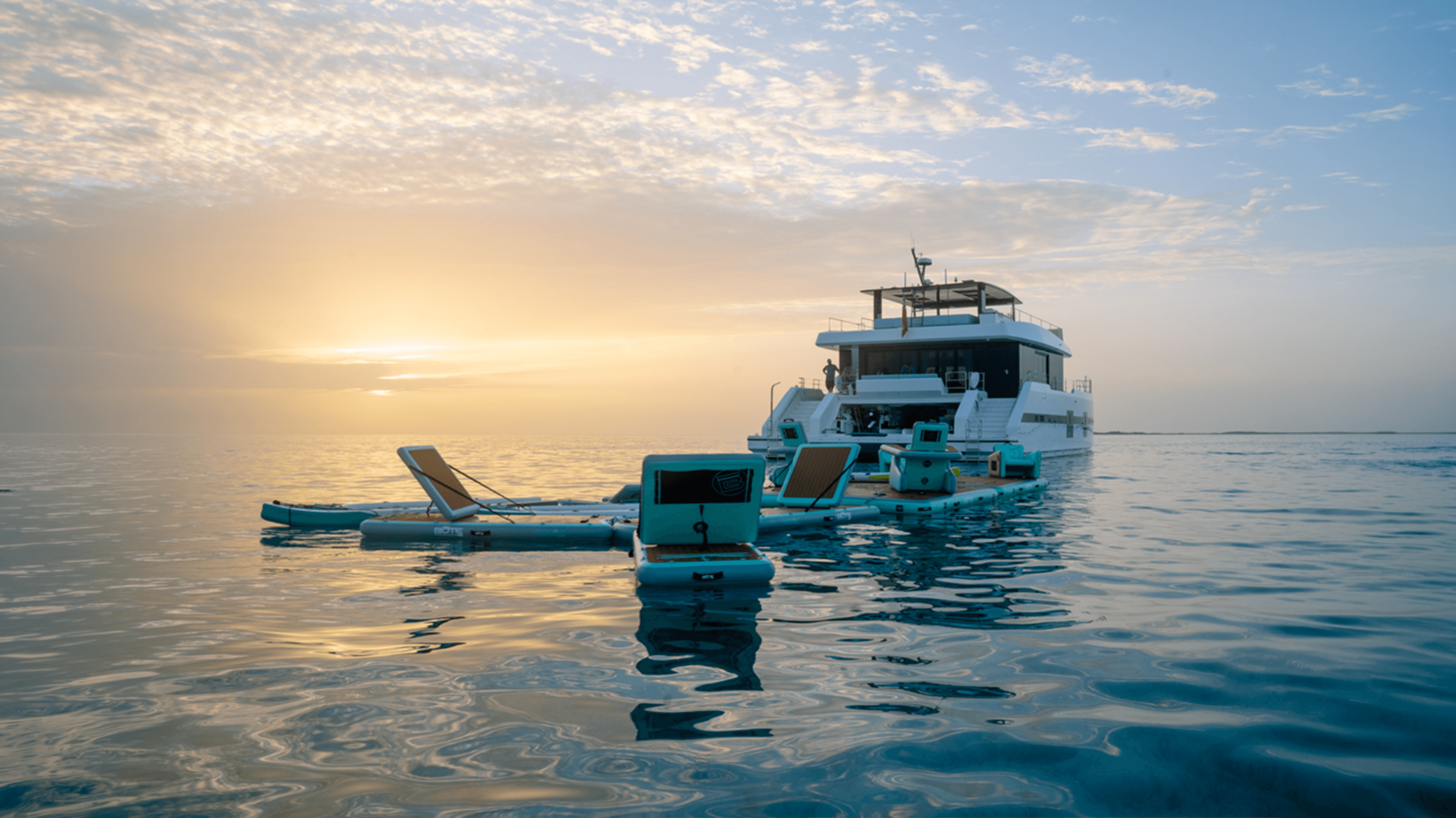 Maria Therese with her water toys on a sunset backdrop.png