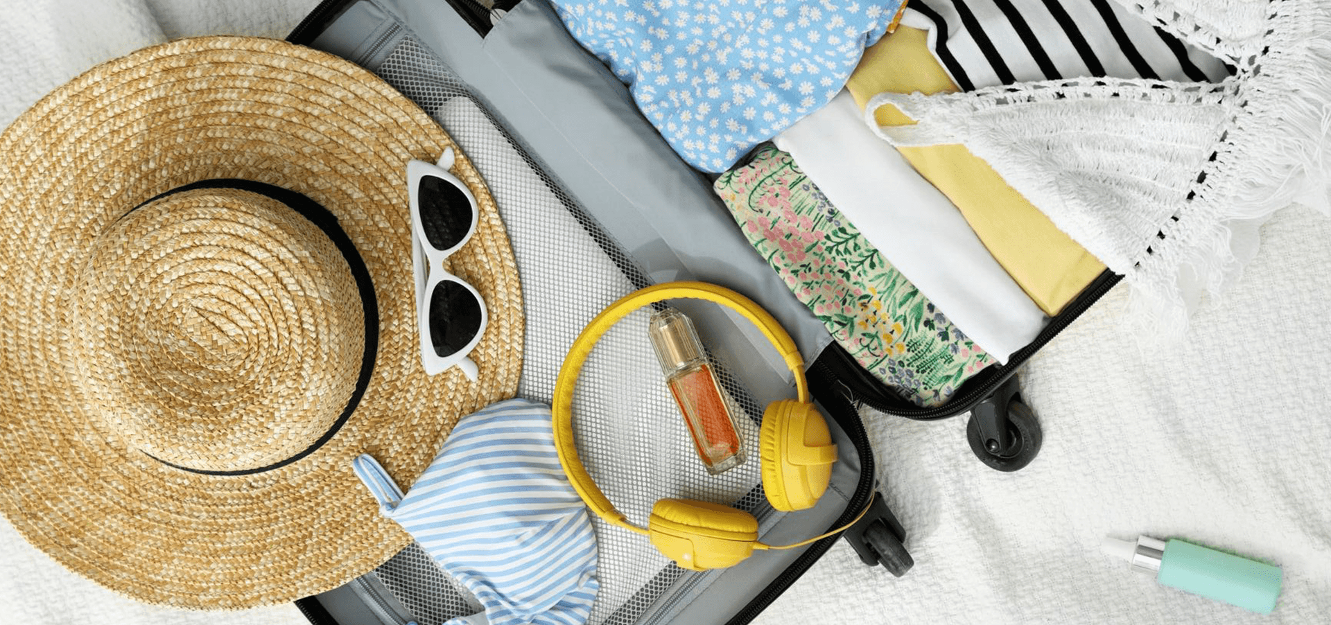 Open luggage with camera and passport.png